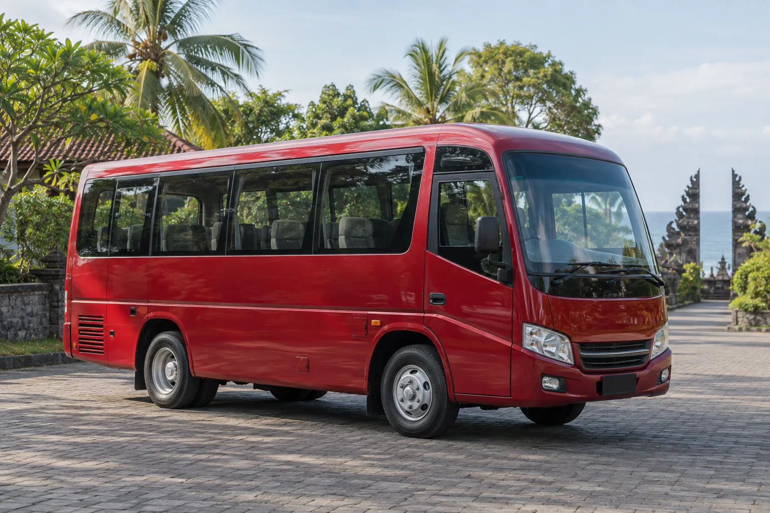Red medium-size tour bus ready for a group departure in North Bali